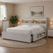 Neatly arranged bedroom with a bed, dressers, and decor.